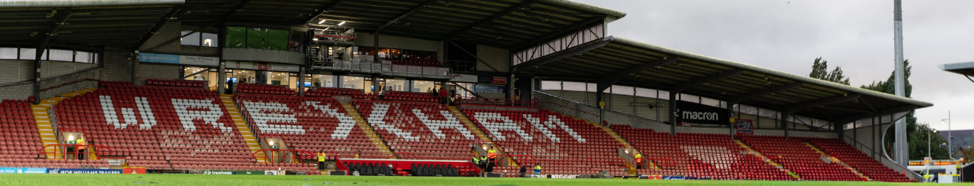 Stadium with 'Wrexham' branding on the seats