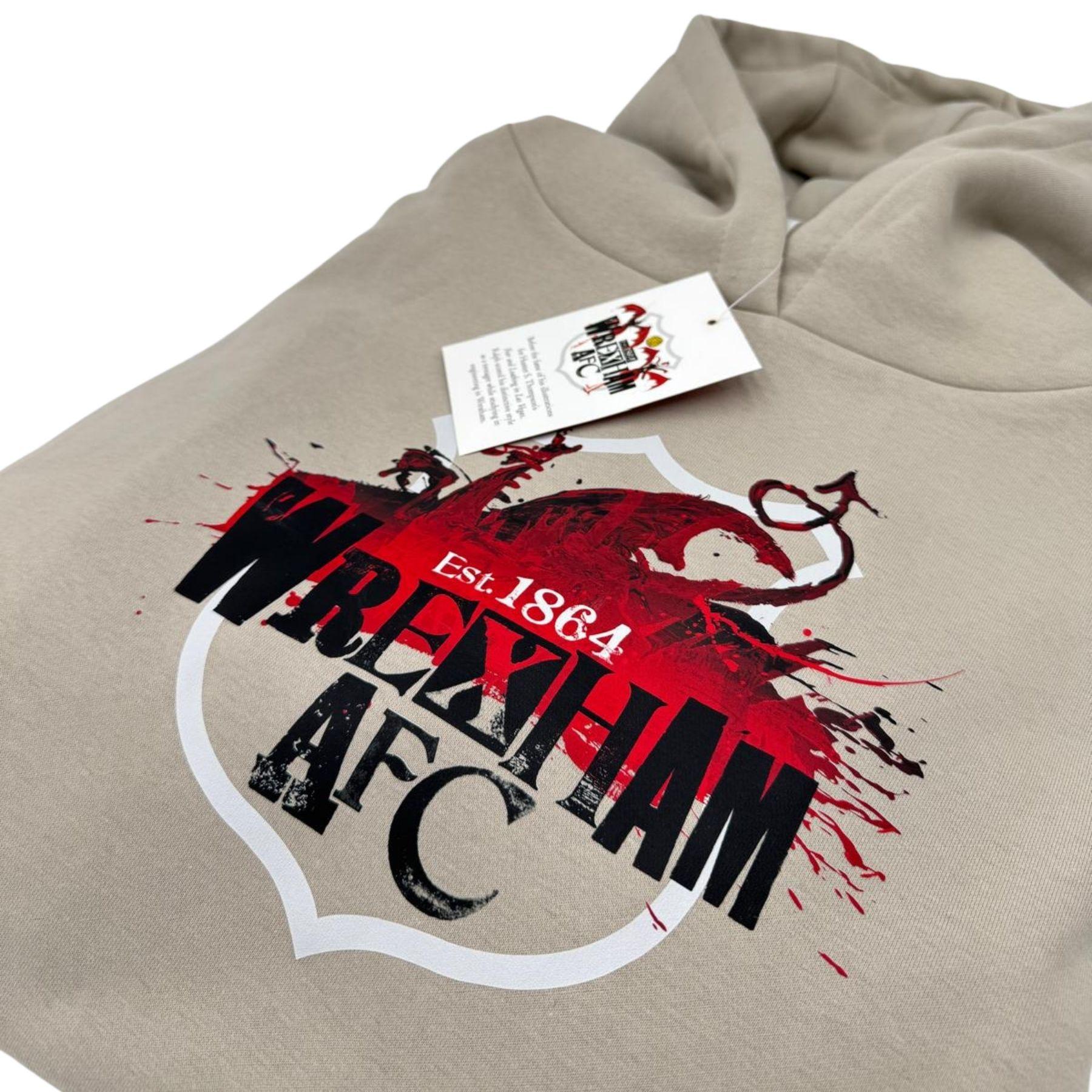 Beige hoodie with red and black 'Wrexham AFC' logo on a white background