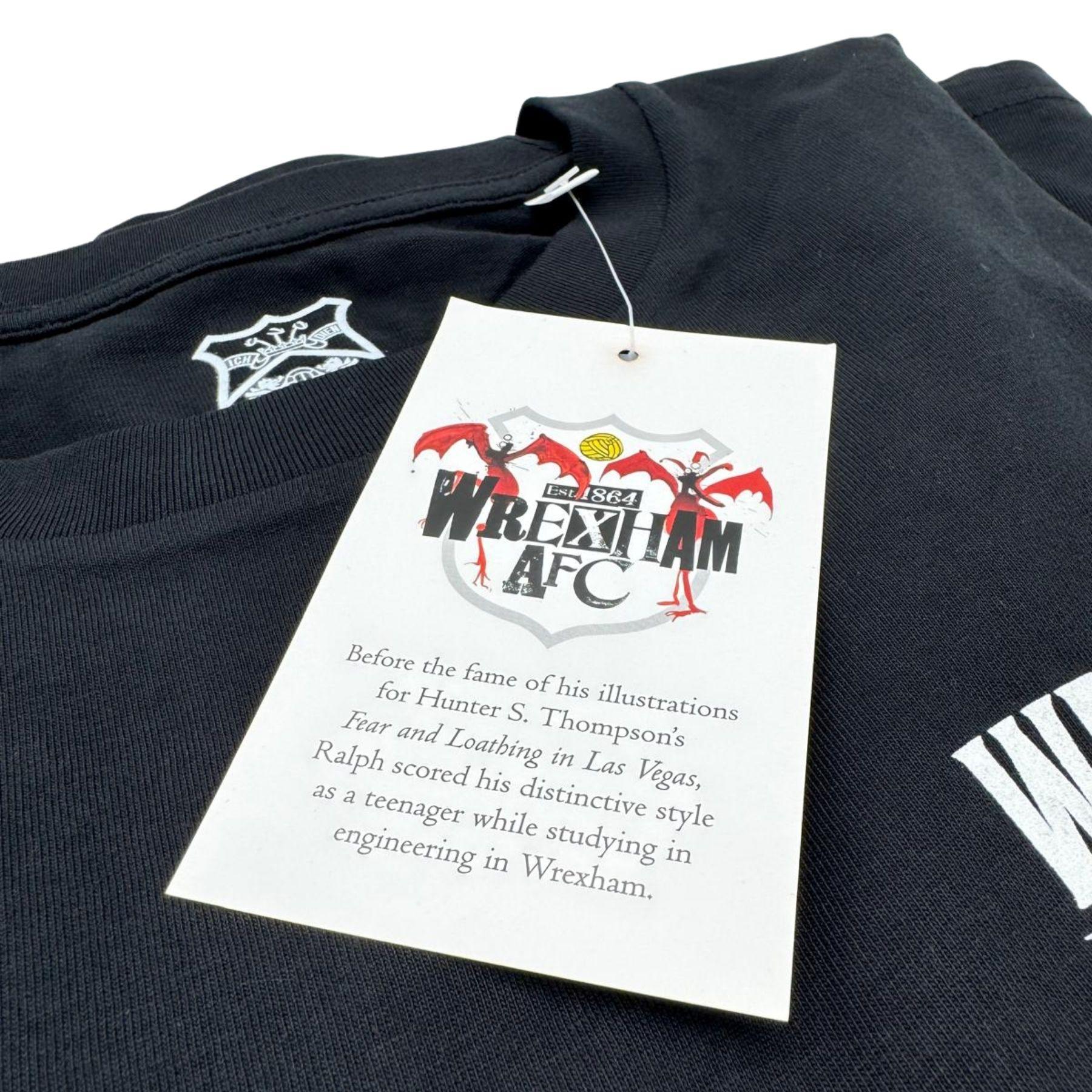 Black t-shirt with a tag featuring Wrexham AFC branding on a white background