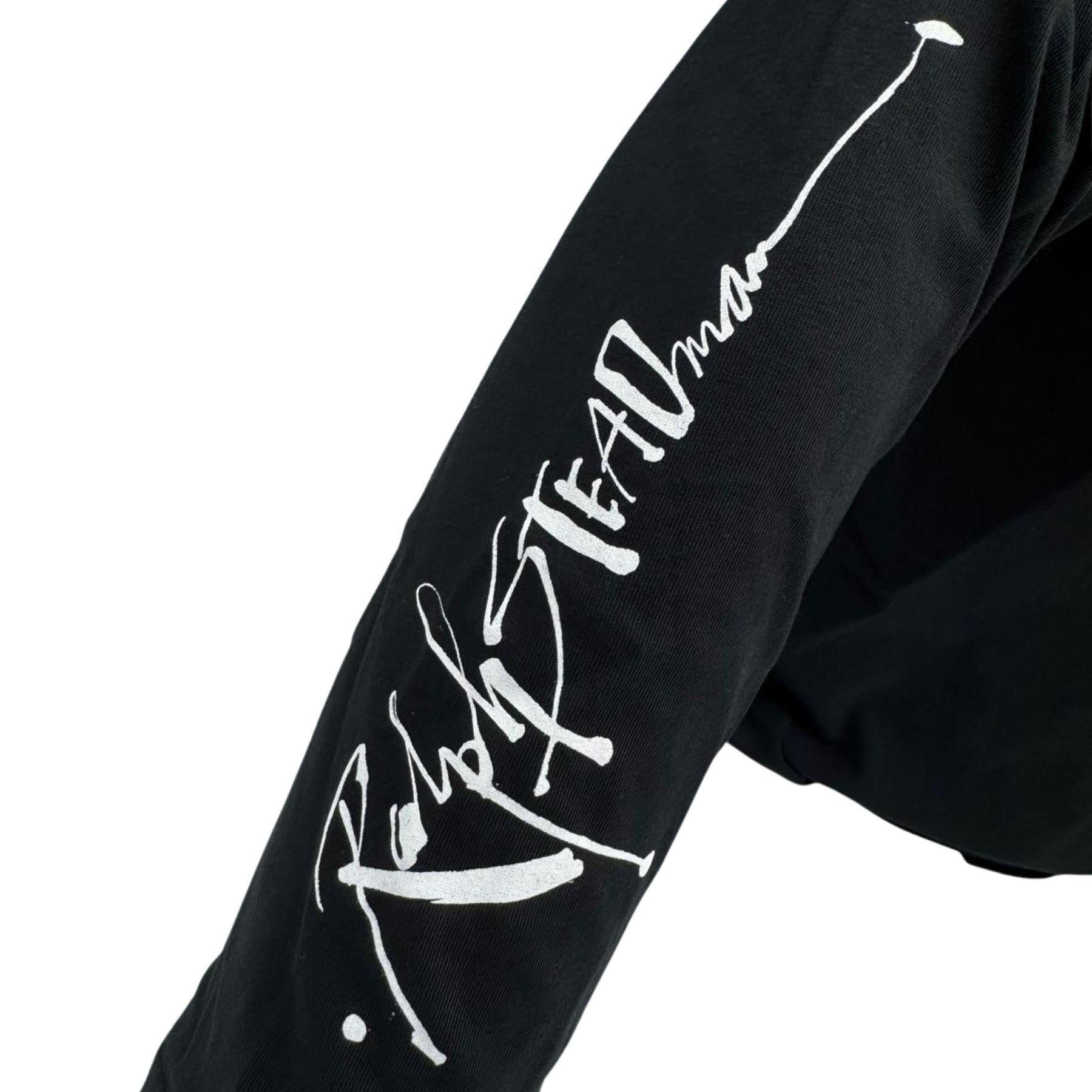 Black sweatshirt sleeve with white text on a white background