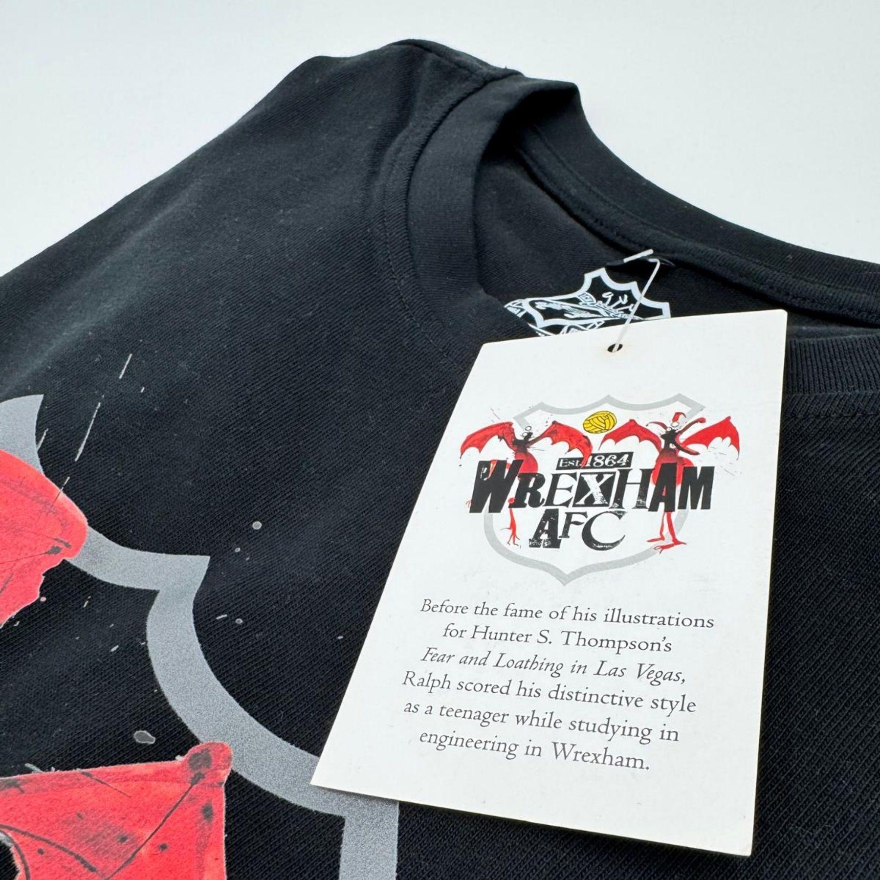 Black t-shirt with red and gray design and Wrexham AFC tag on a white background