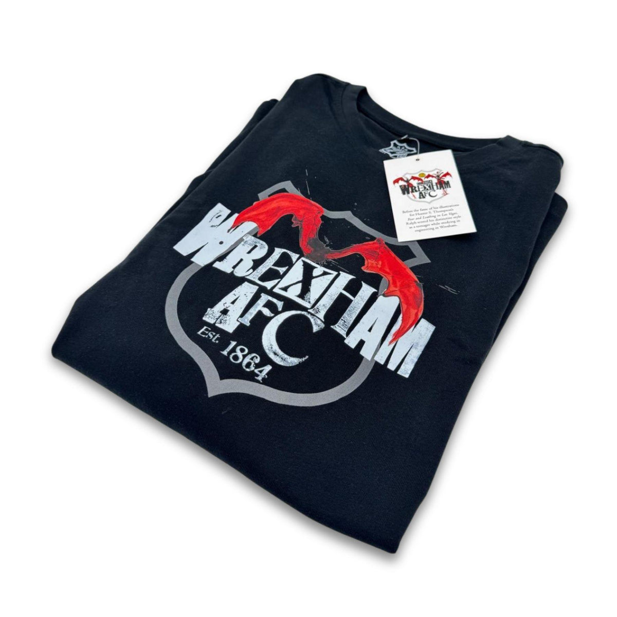 Folded black t-shirt with Wrexham AFC logo on a white background